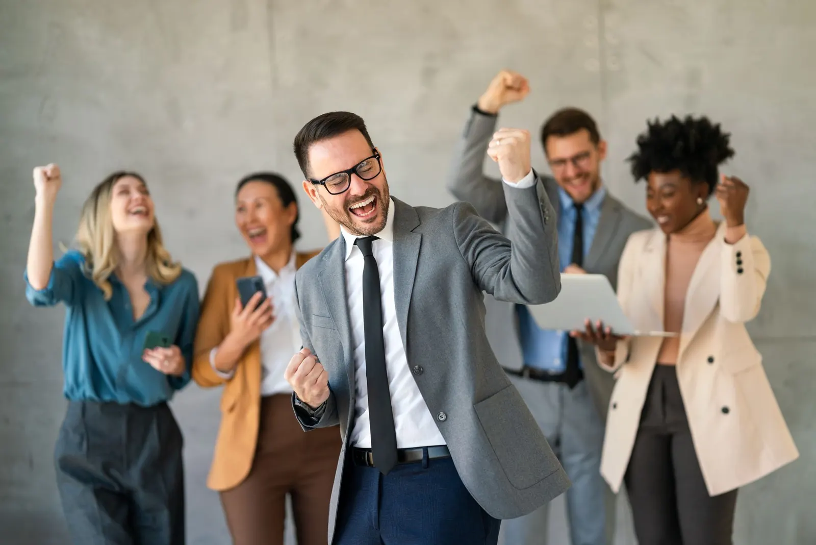 A group of business people are celebrating together.